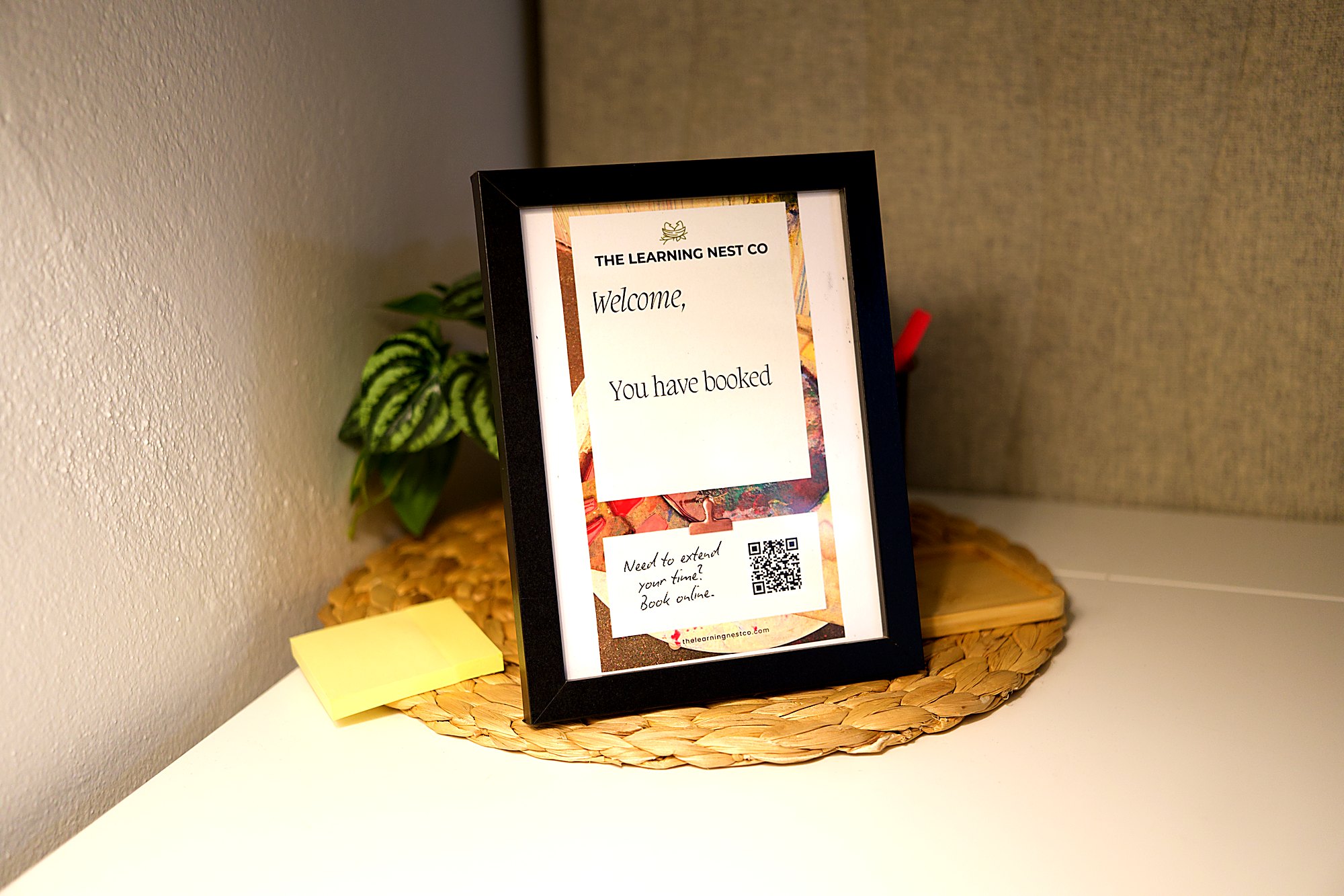 Framed welcome sign in the co-working room at The Learning Nest Co.