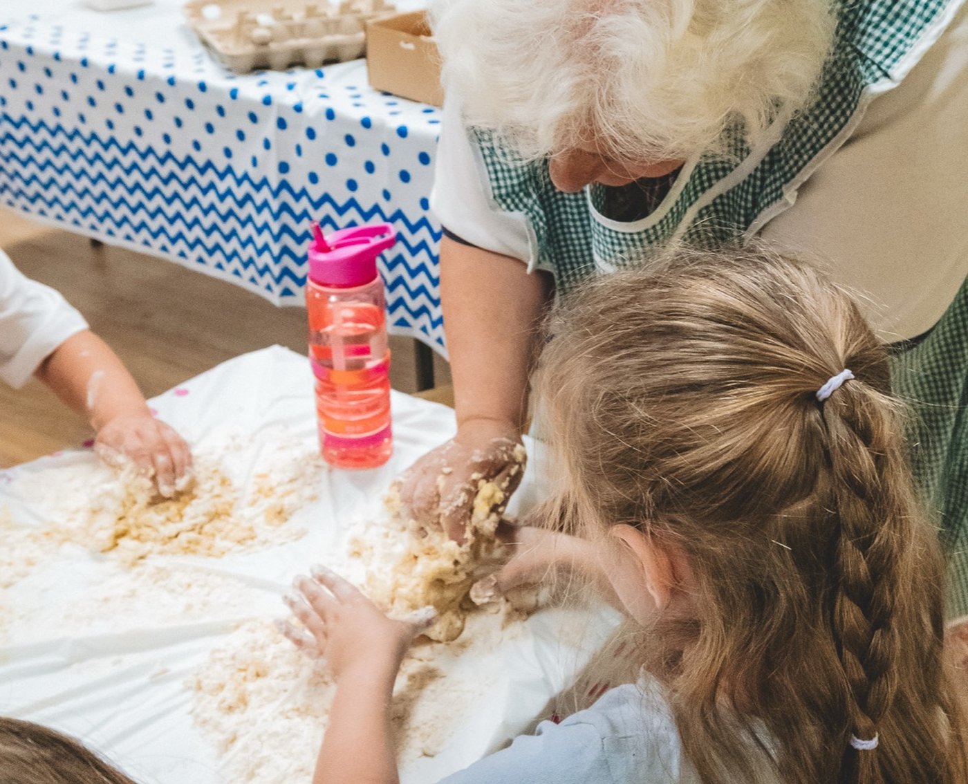 A child and grandparent exploring messy play together at a session